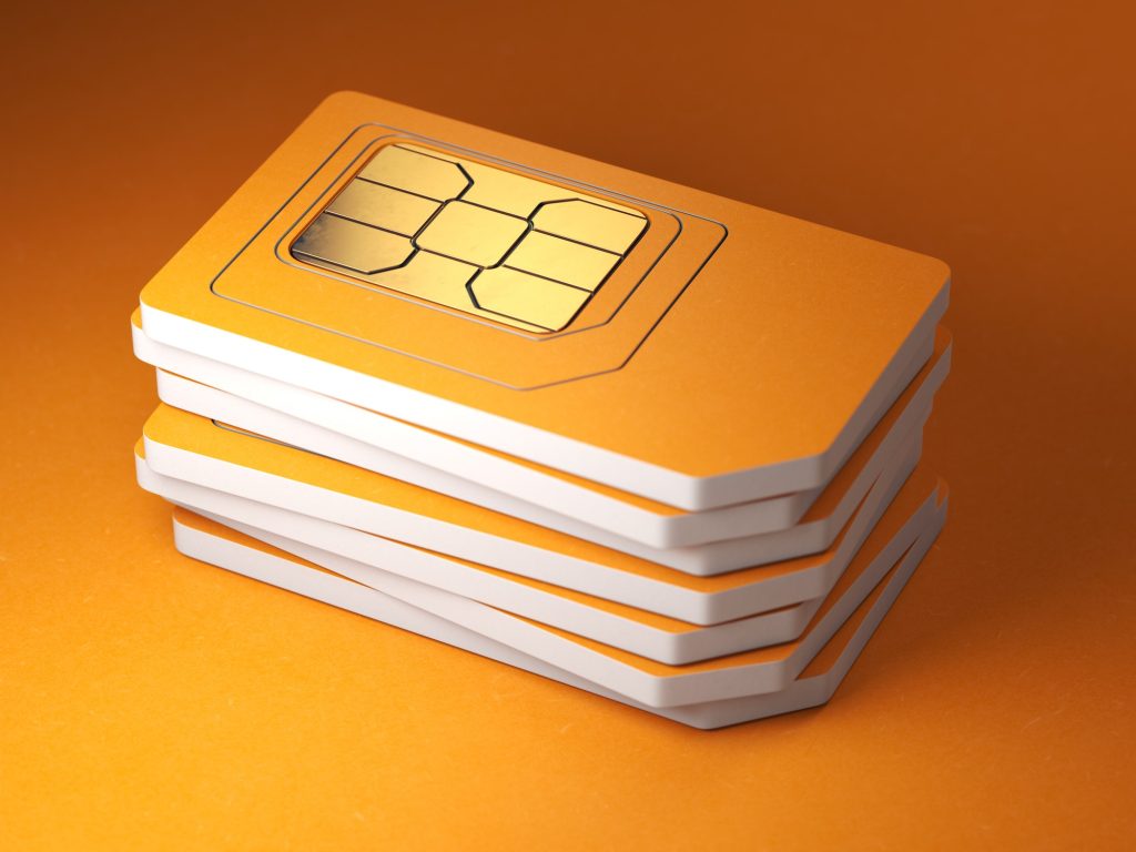 Stack of orange sim smart cards for mobile phone.